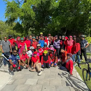 Large group of riders in red shirts