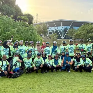 Addu tour group on grass at golden hour