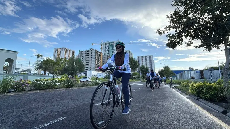 Rider on an open road with the city skyline behind