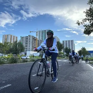 Rider on an open road with the city skyline behind