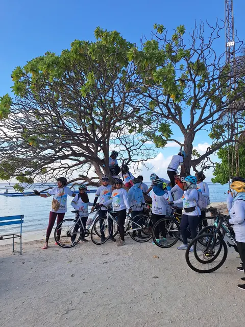 Riders by the sea under a large tree